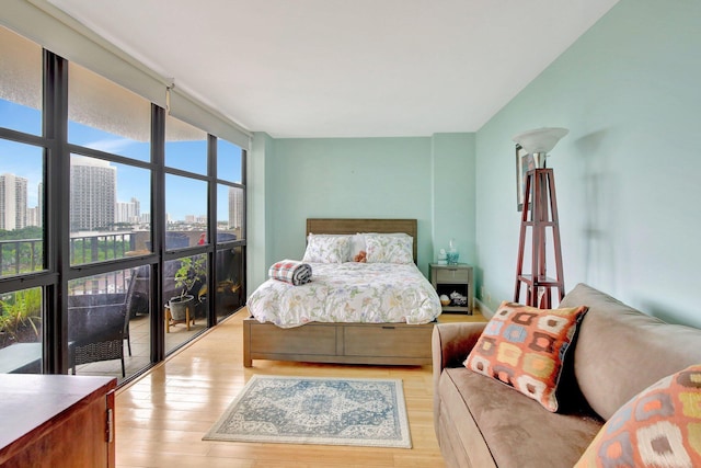 18181 NE 31st Ct Unit 1408, Aventura, FL 33160 - bedroom featuring a view of city, a wall of windows, and light wood-type flooring
