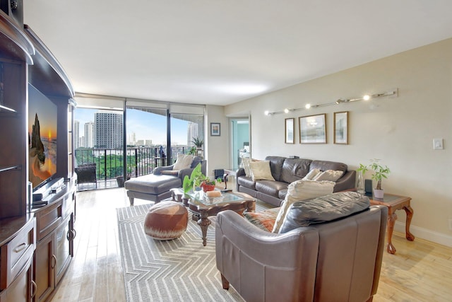 18181 NE 31st Ct Unit 1408, Aventura, FL 33160 - living area featuring a wall of windows and light wood-style flooring