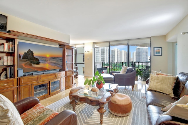 living room with a wall of windows and light hardwood / wood-style floors