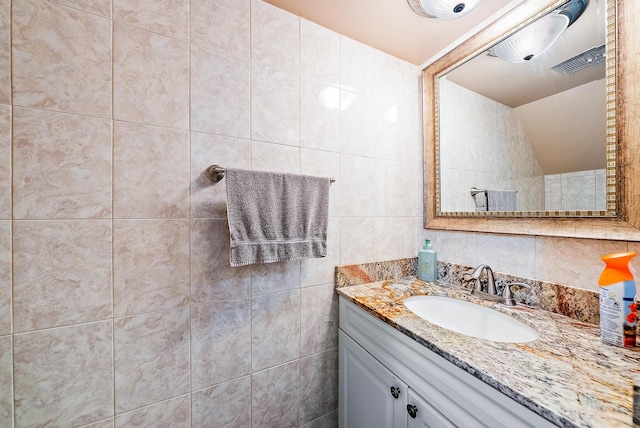 bathroom with tile walls and vanity