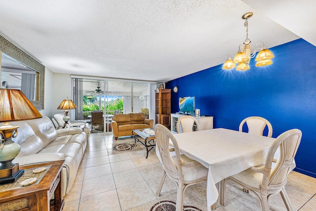 tiled dining area with an inviting chandelier and a textured ceiling