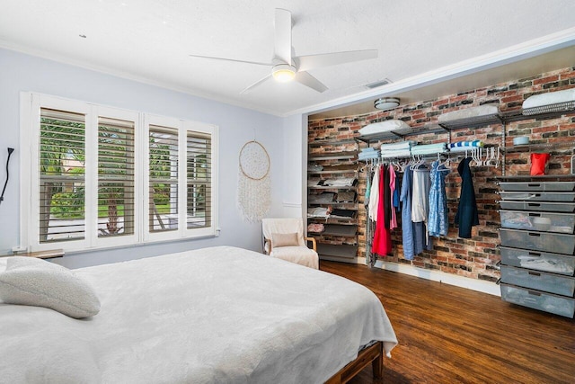 bedroom with dark hardwood / wood-style floors, ceiling fan, ornamental molding, a textured ceiling, and a closet