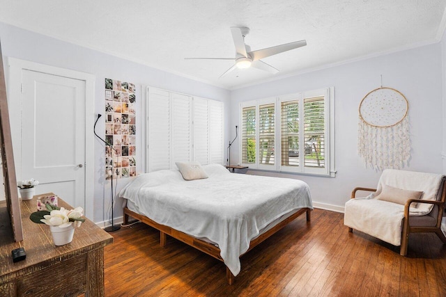 bedroom featuring ceiling fan, dark hardwood / wood-style floors, and ornamental molding