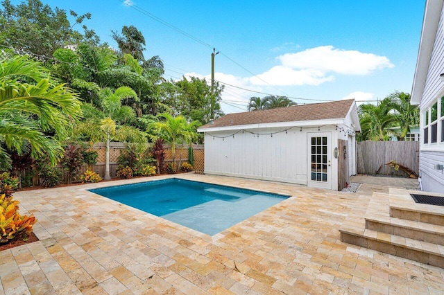 view of swimming pool with a patio area and an outdoor structure