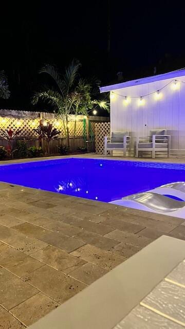 pool at night with a patio