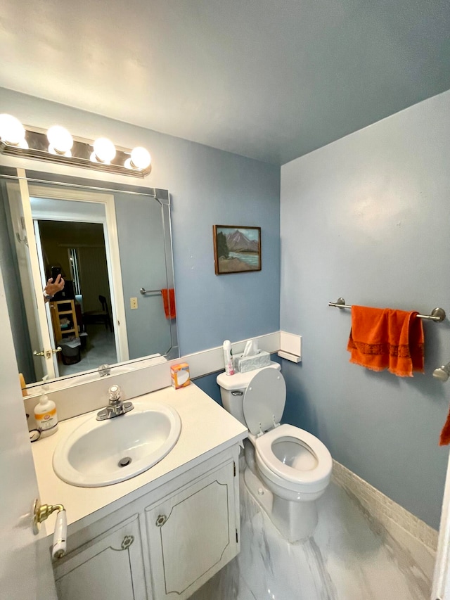 bathroom featuring vanity and toilet