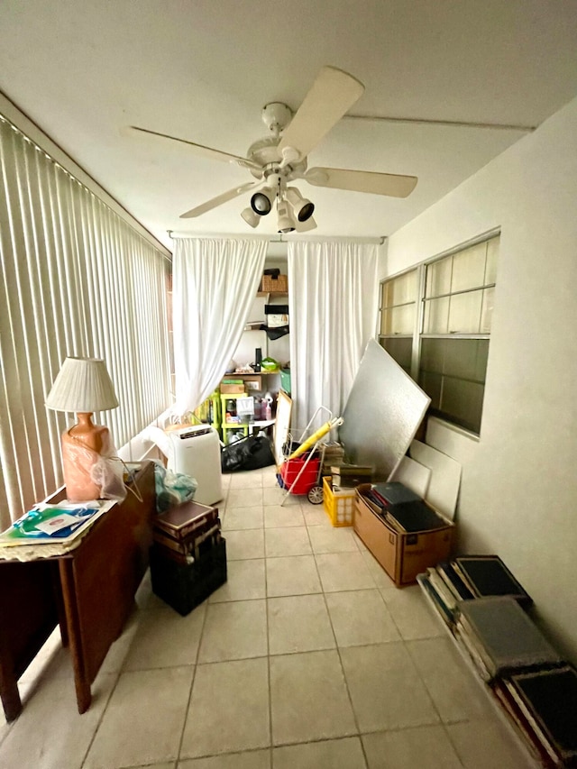 sunroom / solarium featuring ceiling fan