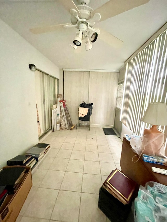 interior space with ceiling fan and light tile patterned floors