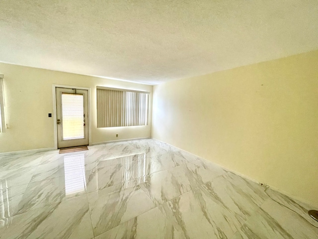 spare room featuring a textured ceiling