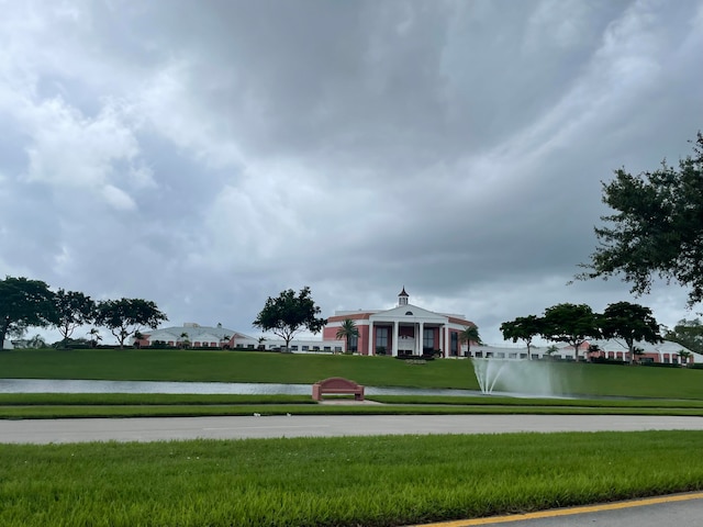 view of community with a lawn and a water view