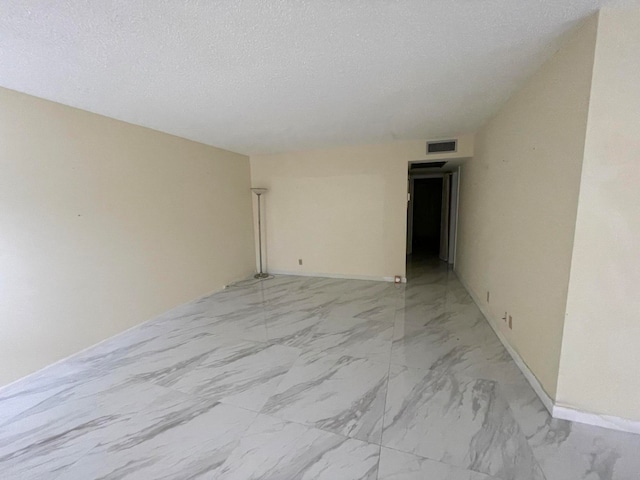 empty room with a textured ceiling