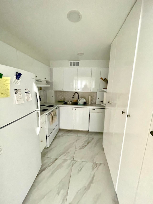 kitchen with white appliances, tasteful backsplash, white cabinetry, and sink