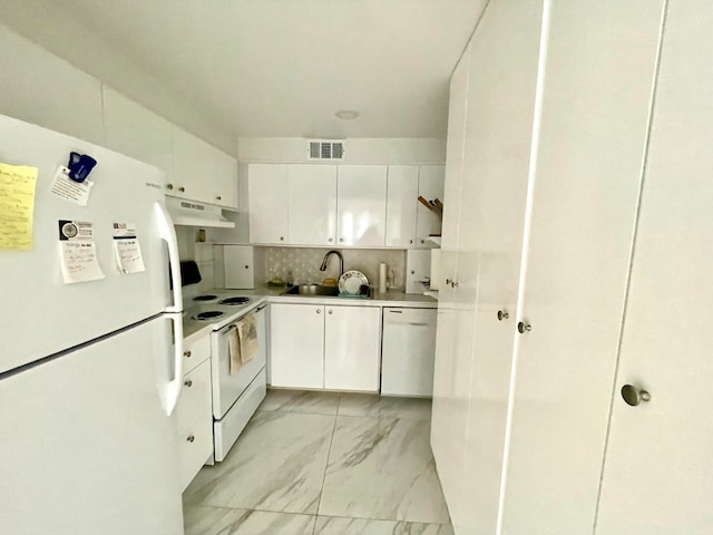 kitchen with white appliances, backsplash, white cabinetry, and sink