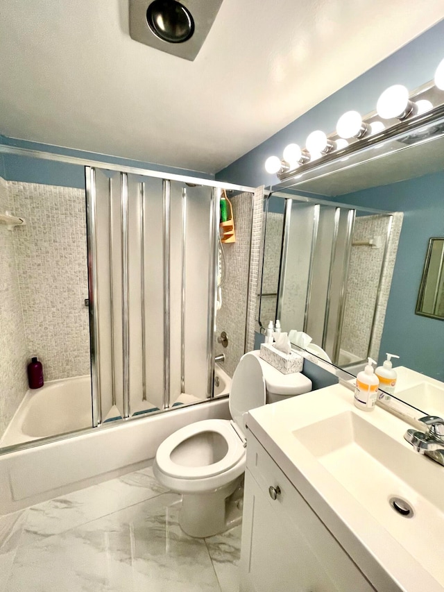 full bathroom featuring vanity, enclosed tub / shower combo, and toilet