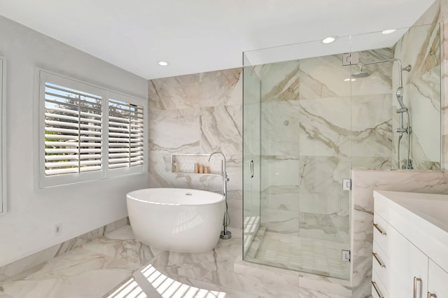 bathroom with vanity and separate shower and tub