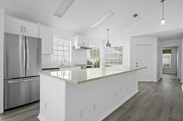 kitchen with hanging light fixtures, white cabinetry, stainless steel appliances, and a center island