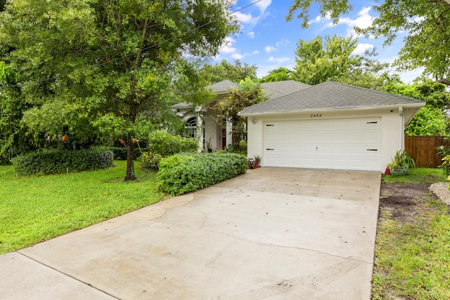 view of front of property featuring a front yard and a garage