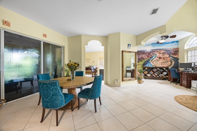 tiled dining area featuring ceiling fan