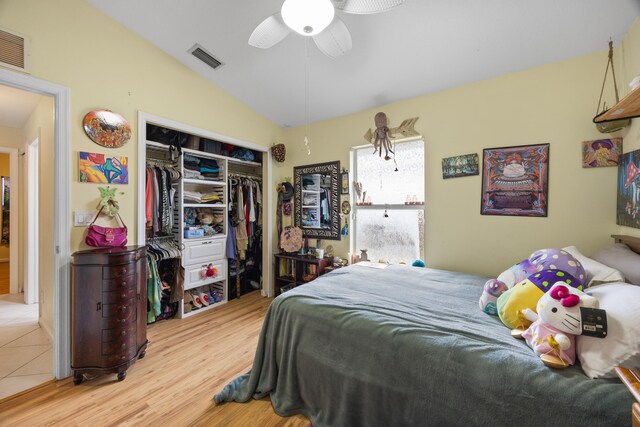 bedroom featuring a closet, vaulted ceiling, ceiling fan, and light hardwood / wood-style floors