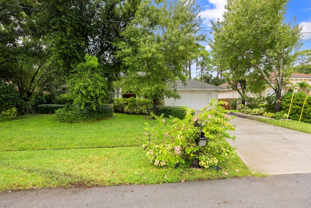 view of front of house featuring a front lawn and a garage