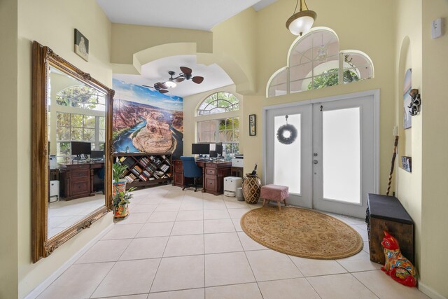 entrance foyer featuring light tile patterned floors, a healthy amount of sunlight, and french doors