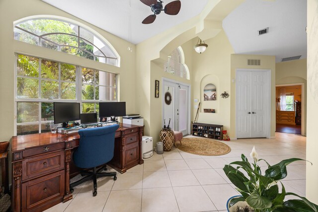 office space with high vaulted ceiling, ceiling fan, and light tile patterned flooring