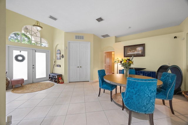 dining room featuring light tile patterned floors and french doors