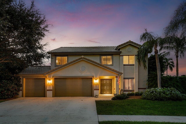 view of front of home with a lawn and a garage