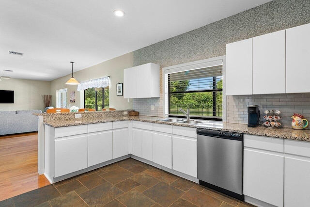 kitchen featuring sink, dishwasher, white cabinets, and plenty of natural light