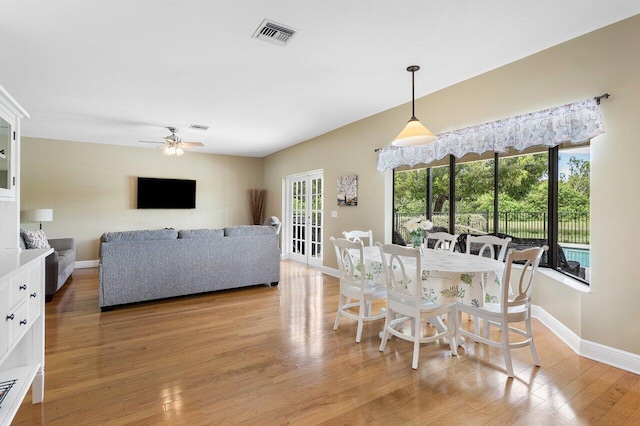 dining area with light hardwood / wood-style floors and ceiling fan