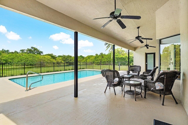 view of swimming pool with a patio and ceiling fan