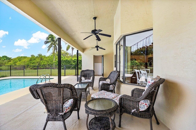 view of patio / terrace with an outdoor living space, a fenced in pool, and ceiling fan