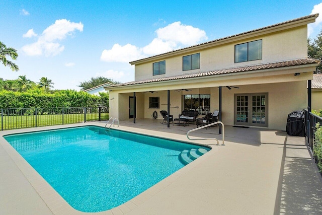 view of pool with a patio and ceiling fan