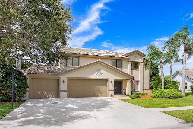 mediterranean / spanish-style home featuring a front yard and a garage