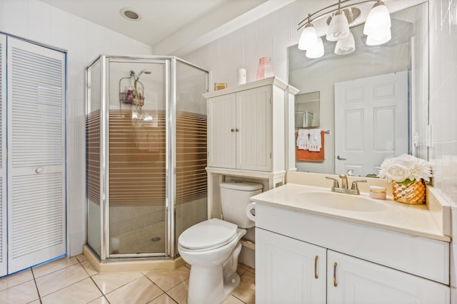 bathroom featuring vanity, tile walls, tile patterned flooring, a shower with shower door, and toilet