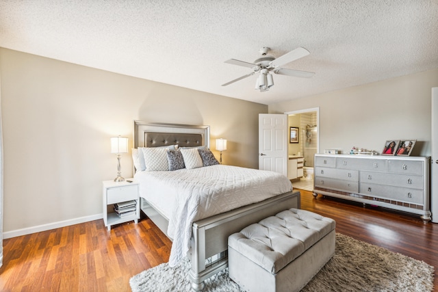 bedroom with dark hardwood / wood-style floors, ensuite bathroom, a textured ceiling, and ceiling fan