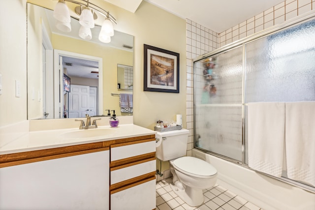 full bathroom featuring tile patterned floors, toilet, bath / shower combo with glass door, and vanity