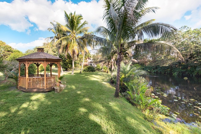 view of yard featuring a gazebo and a water view