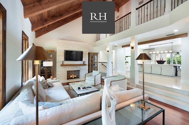 living room featuring beamed ceiling, hardwood / wood-style flooring, wood ceiling, and high vaulted ceiling