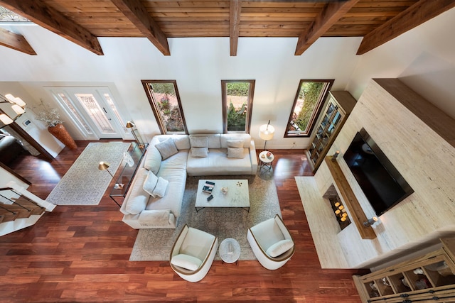 living room with high vaulted ceiling, beamed ceiling, and dark hardwood / wood-style flooring