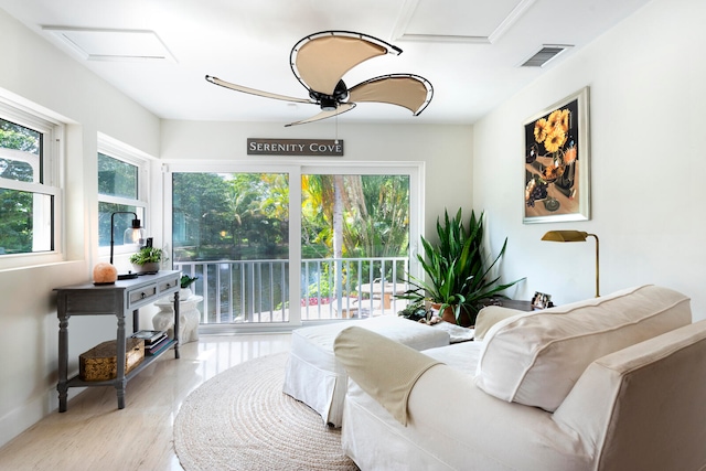 living area with ceiling fan and light wood-type flooring