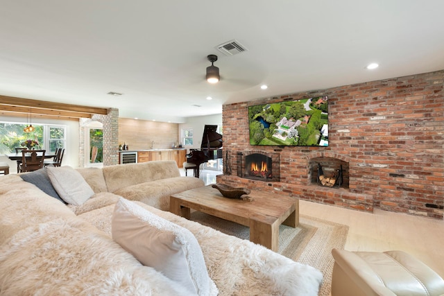 living room featuring a fireplace, ceiling fan, brick wall, and wine cooler