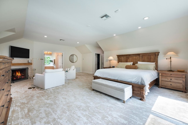 bedroom with lofted ceiling and light colored carpet