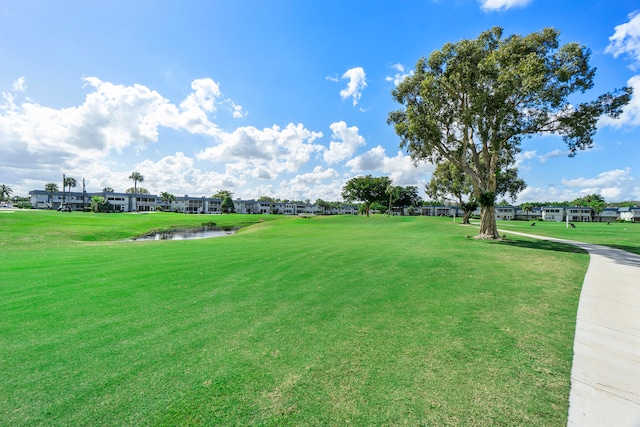 view of community featuring a yard and a water view