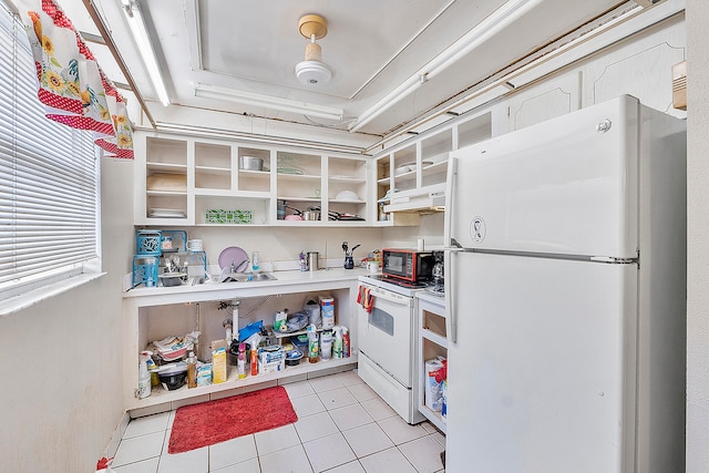 kitchen featuring white appliances, light tile patterned floors, and premium range hood