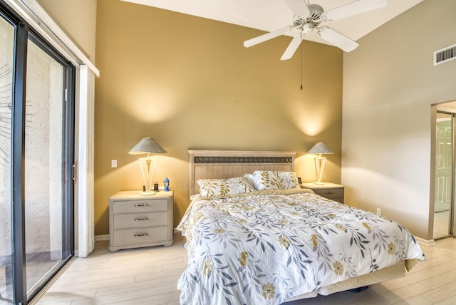 bedroom with access to outside, light hardwood / wood-style flooring, and ceiling fan