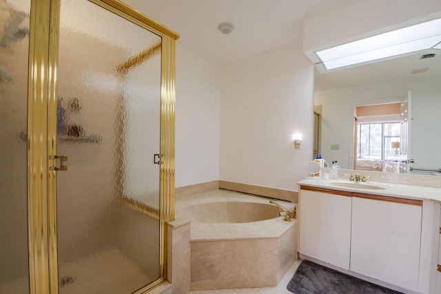 bathroom featuring tile patterned flooring, vanity, and independent shower and bath