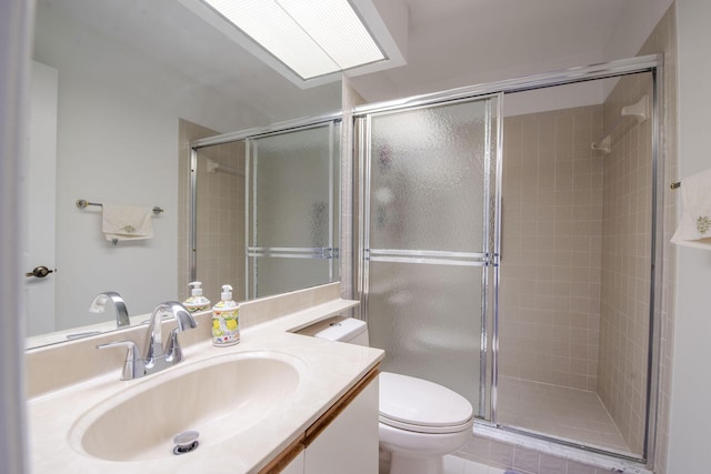 bathroom with tile patterned flooring, vanity, toilet, and walk in shower