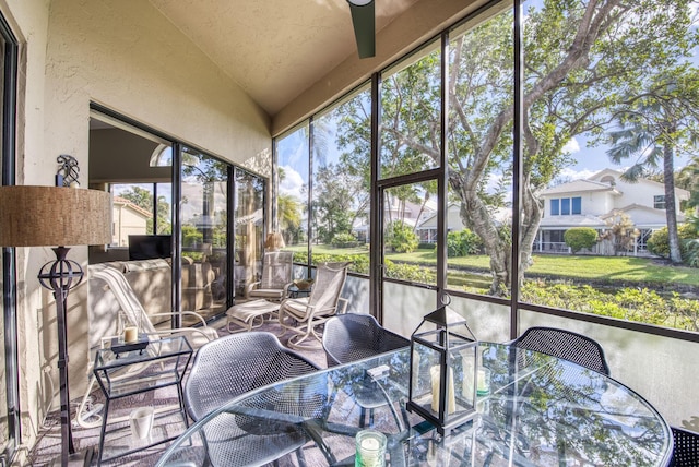 sunroom with vaulted ceiling and plenty of natural light