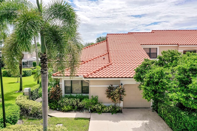 mediterranean / spanish-style home with a front lawn and a garage